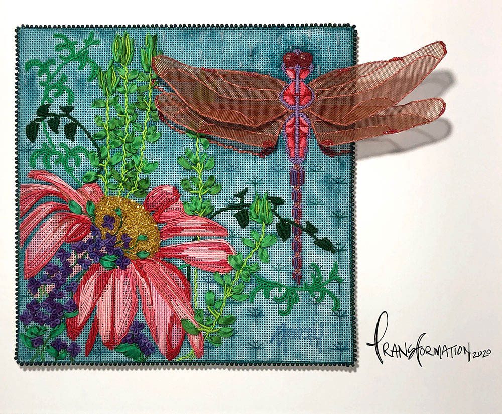 Needlepoint artwork of a dragonfly and a pink flower.